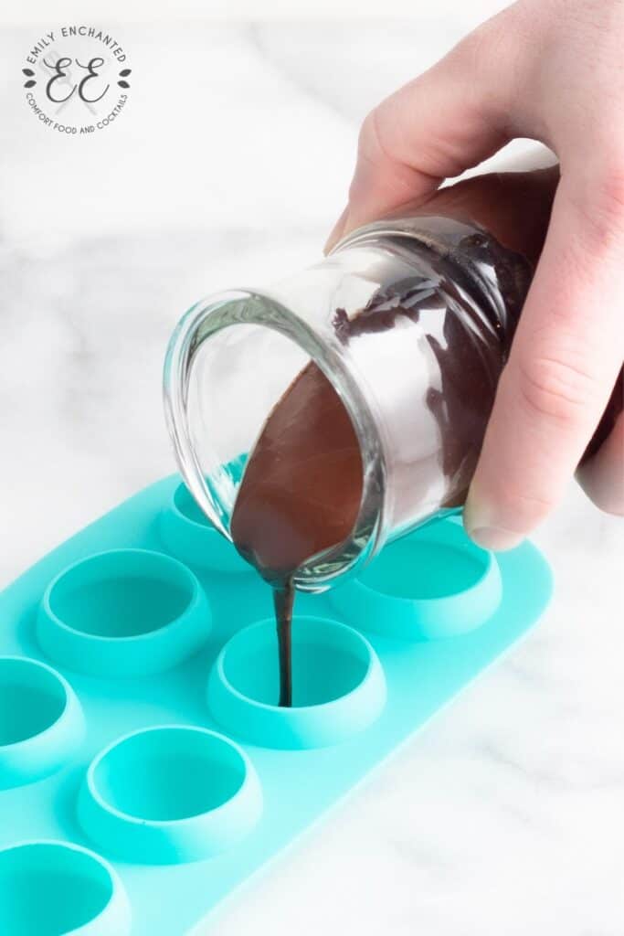 Pouring chocolate into a truffle tray