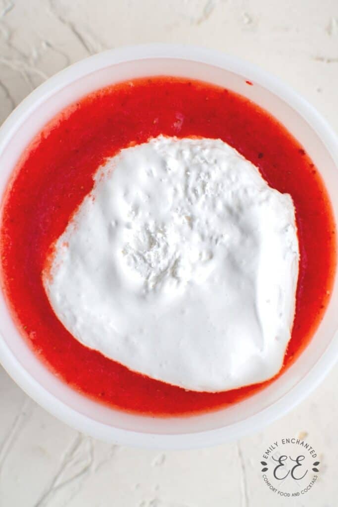 melted Marshmallow Fluff and Strawberry Puree in a bowl