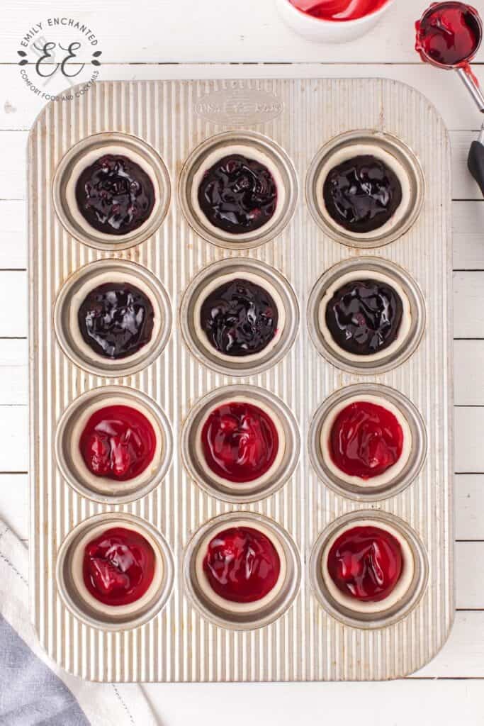 Blueberry and Strawberry Pie Filling in mini pie crusts in a muffin pan