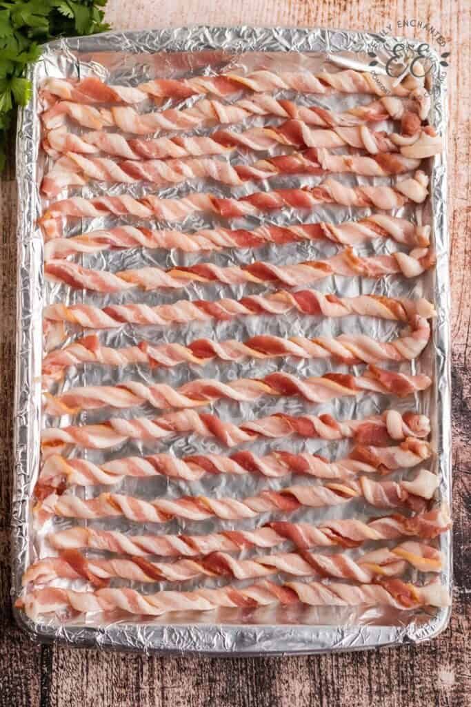 Oven Baked Bacon Twisted Strips of Bacon on a Baking Sheet