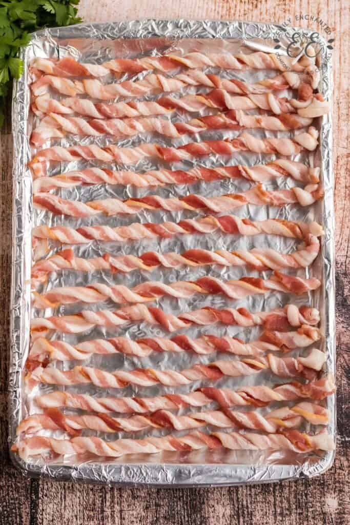 Twisted Strips of Bacon on a Baking Sheet