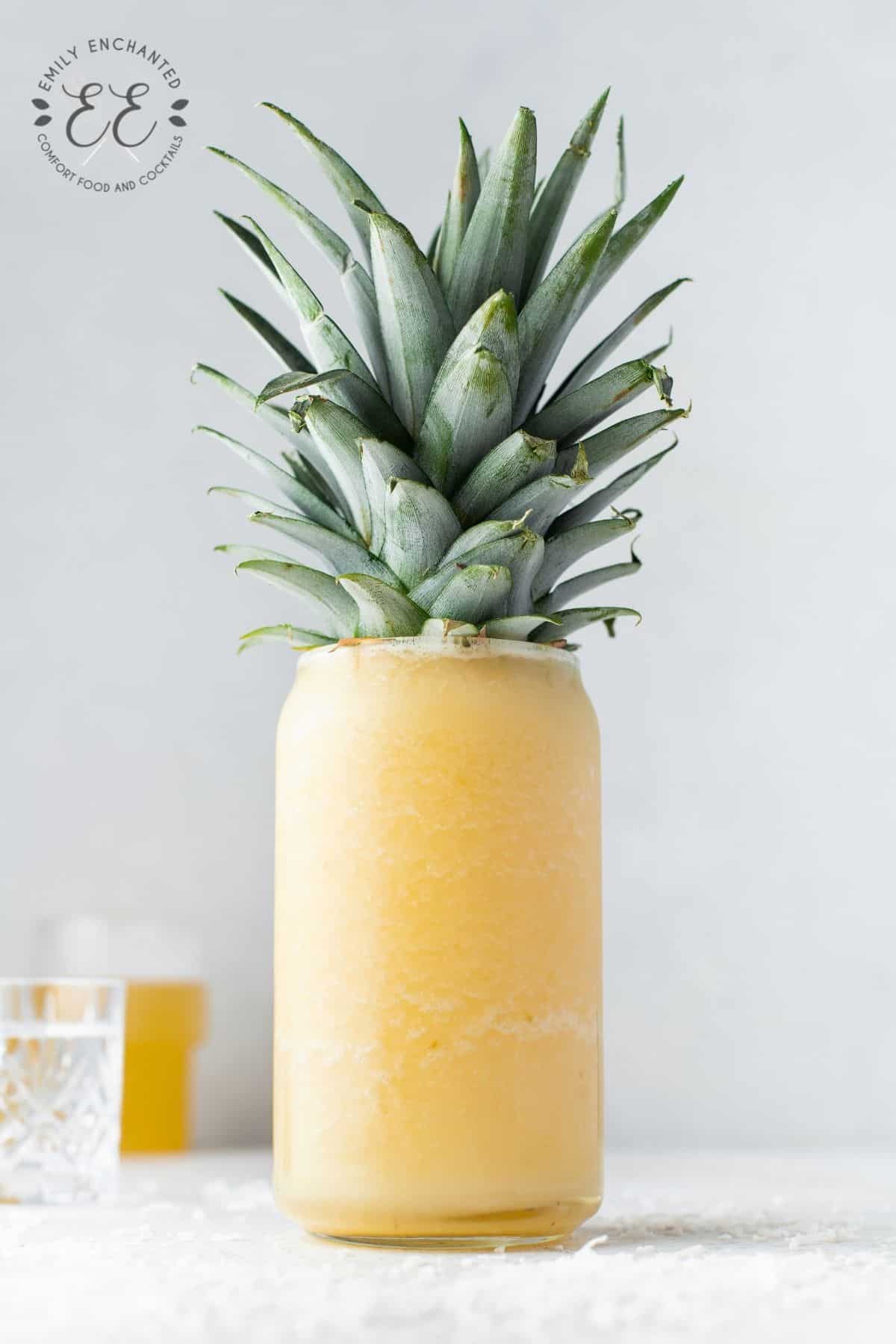 Frozen Piña Colada in a glass with the rosette of leaves as garnish
