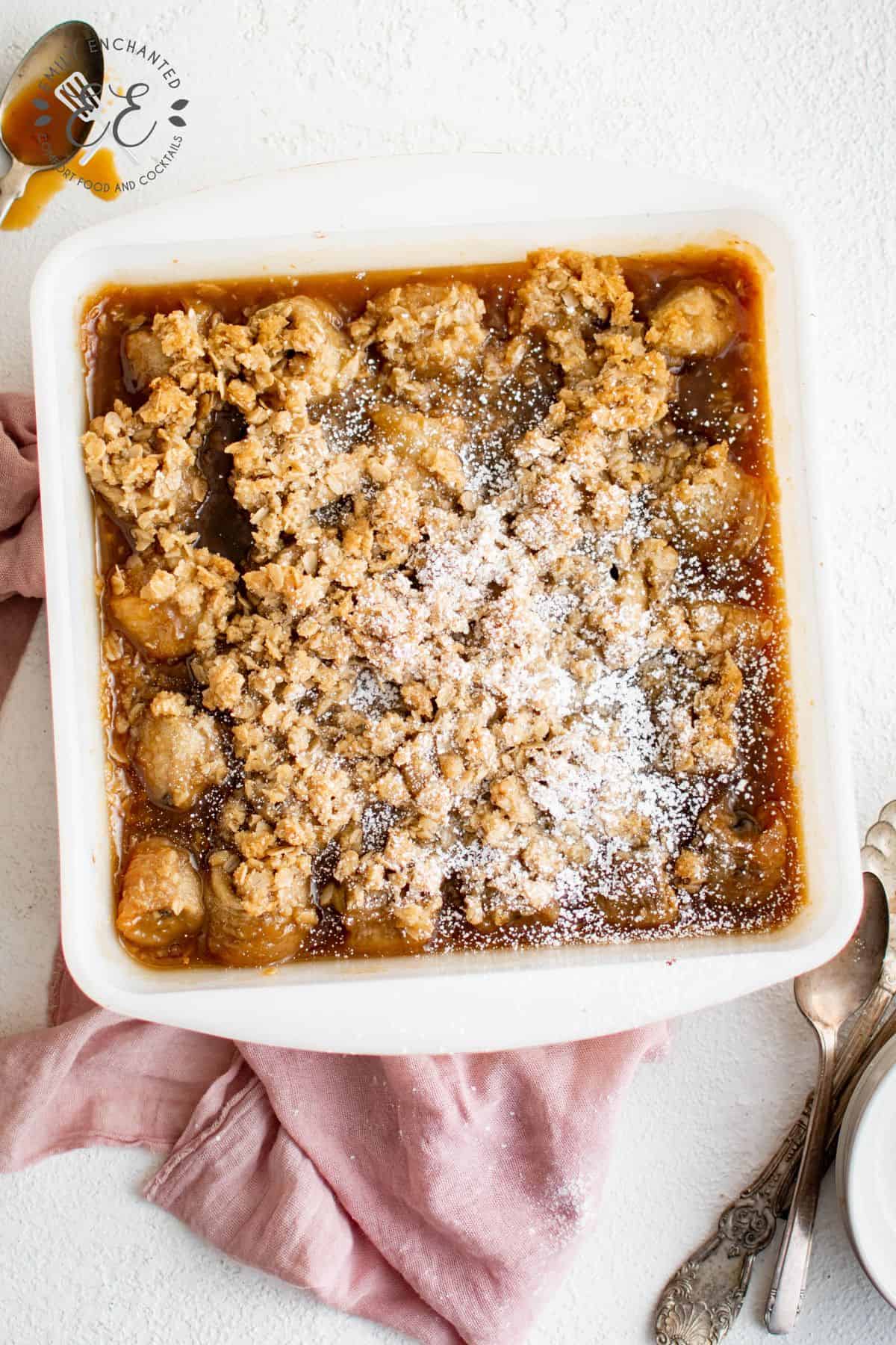 Banana Crumble in a white square baking dish with a red towel under it