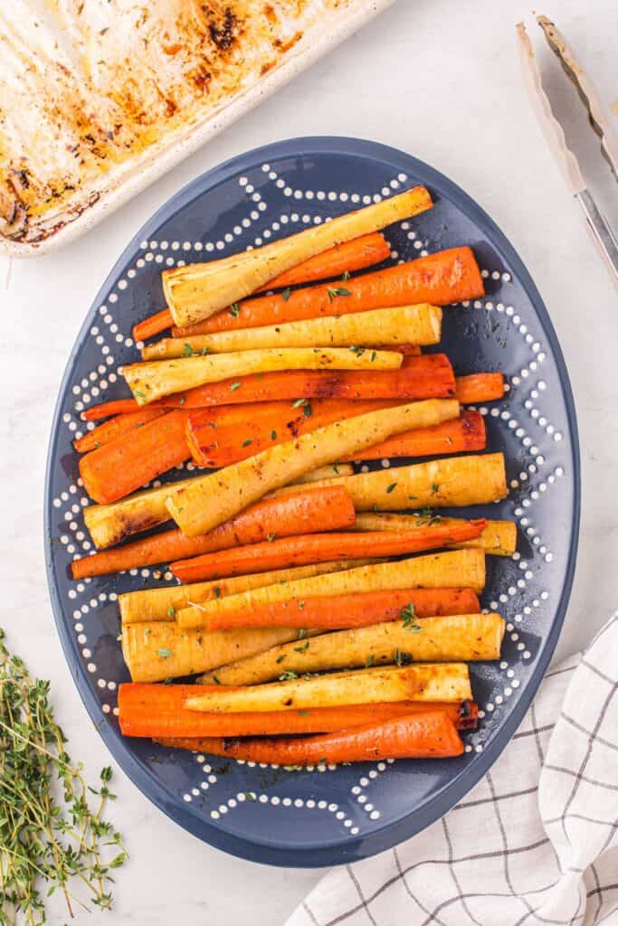 Honey Roasted Carrots and Parsnips on a blue oval platter