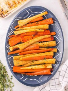 Honey Roasted Carrots and Parsnips on a blue oval platter